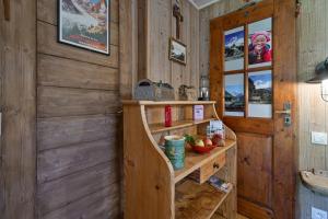 a bathroom with wooden walls and a sink and a shelf at Chambre D'hôtes La Télécabine in La Balme-de-Thuy