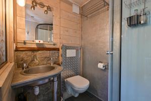 a small bathroom with a sink and a toilet at Chambre D'hôtes La Télécabine in La Balme-de-Thuy