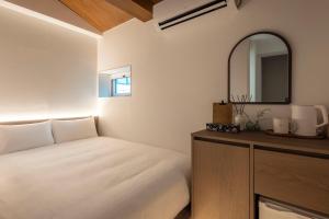 a bedroom with a white bed and a mirror at YUONJAE Jongno in Seoul