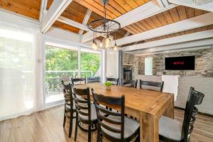 a dining room with a wooden table and chairs at Pool & Spa - Chalet Le Misco in Beaupré