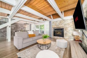 a living room with a couch and a fireplace at Pool & Spa - Chalet Le Misco in Beaupré