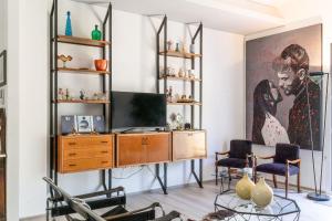 a living room with a tv and a painting on the wall at Italian Experience-Art&Sea House in Fano