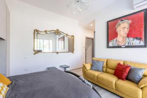 a living room with a couch and a mirror at Italian Experience-Art&Sea House in Fano