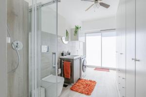 a white bathroom with a toilet and a shower at Italian Experience-Art&Sea House in Fano +34 photos
