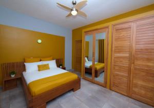 a bedroom with a bed and a ceiling fan at Villa de détente "Tombosoa" avec vue sur la baie de Diego-Suarez in Antsiranana +37 photos