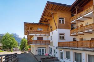 a large building with wooden balconies on it at Appartamenti Lella in Vigo di Fassa
