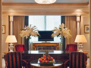 a living room with a table and a television at Mövenpick Hotel Al Khobar in Al Khobar +226 photos