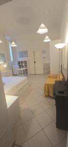a room with a bed and a tiled floor at Gabici Suite Ravenna in Ravenna