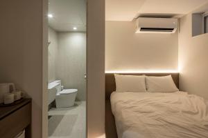 a small bedroom with a bed and a toilet at YUONJAE Jongno in Seoul +96 photos