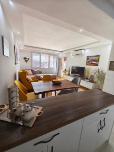 a kitchen and living room with a table at Ana VS Apartment in Ohrid