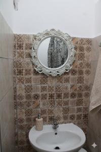 a bathroom with a white sink and a mirror at Aloni Studio in Azoyirás +41 photos