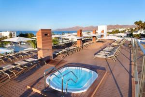 a hot tub on the deck of a resort at Plus Fariones Apartamentos in Puerto del Carmen +42 photos