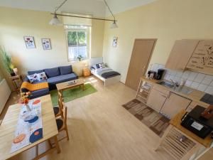 a living room with a blue couch and a table at Ferienwohnung Barbarossa - Holly in Rottleben