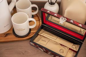 a box of mugs and cups on a table at YUONJAE Jongno in Seoul