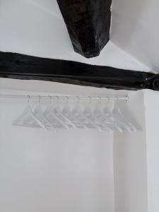 a bunch of white hangers hanging from a ceiling at Brewhouse Cottage 18th Century Cottage -Three Peaks Settle in Settle