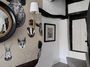 a room with a wall with animal masks on it at Brewhouse Cottage 18th Century Cottage -Three Peaks Settle in Settle
