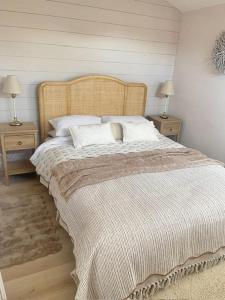 a bedroom with a large bed with two night stands at Alder House Lytham in Lytham St Annes