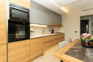 a kitchen with a wooden table and a black appliance at Casa di Babii in Serle