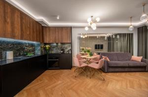 a kitchen and living room with a couch and a table at Apartament Bursztynowa Komnata 116 Stegna nad morzem in Stegna