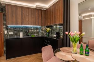 a kitchen with a table with flowers on it at Apartament Bursztynowa Komnata 116 Stegna nad morzem in Stegna +36 photos