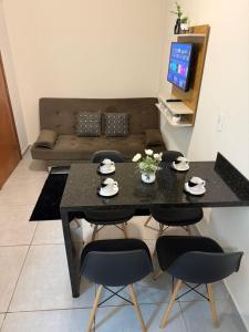 a living room with a black table and chairs at Self check-in Garagem Ar 13 min ABQM in Araçatuba +24 photos