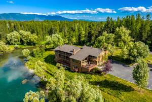 an aerial view of a house next to a river at Duck Inn Lodge in Whitefish