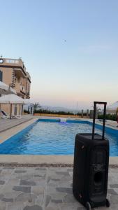a suitcase sitting next to a swimming pool at Nuweiba house camp in Nuweiba