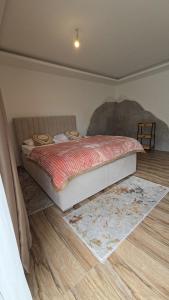 a bedroom with a bed and a rug on the floor at Lux studio - Vrh Đevojka in Borje