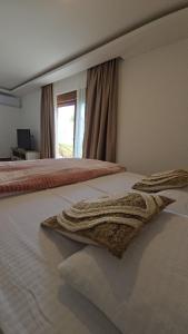 a bedroom with a bed with two towels on it at Lux studio - Vrh Đevojka in Borje