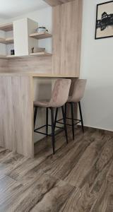 a room with a wooden floor with a table and chairs at Lux studio - Vrh Đevojka in Borje +2 photos