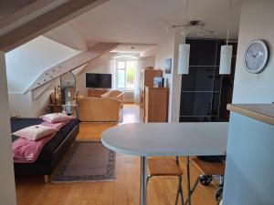 a living room with a bed and a table at Rosarote Insel - La Vie en Rose in Lindau