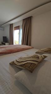 a bedroom with a bed with two towels on it at Lux studio - Vrh Đevojka in Borje