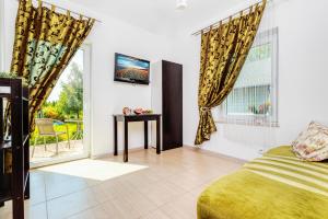 a bedroom with a bed and a window and a table at Pokoje JANTARUS in Jantar