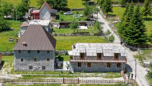 an aerial view of a large stone house at Kulla e Sadri Lukes in Theth