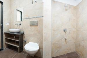 a bathroom with a toilet and a sink at Hotel O Noida Sky Suites Sector 44 Near botanical metro in Badarpur