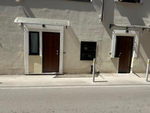 two doors on the side of a building at Aer in Caserta