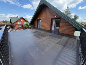 a house with a large deck with a building at Pulmo Rest House in Pulʼmo
