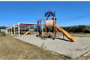 a playground with a yellow slide and a slideintend at Marinière in Sainte-Croix-de-Verdon