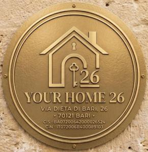 a gold coin with a home sign on a wall at YOUR HOME 26 in Bari