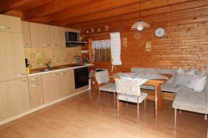 a kitchen and dining room with a table and chairs at Ferienhaus Großmann in Drognitz