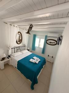 a blue and white bedroom with a bed and a window at Mykonos Secret Spot in Mikonos +105 photos