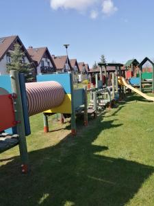 a row of playground equipment in a park at Apartament Jaśkowy in Żarnowska
