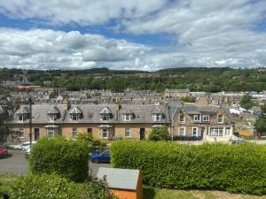 a row of houses in a town with cars parked at Kilnhill in Hawick