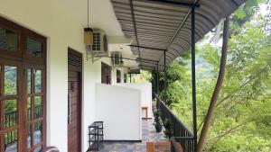 an external view of a house with a white door at Forest Rawana homestay Ella in Ella