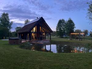 a building with a reflection in the water at Mihkliranna Puhkemaja in Marksa