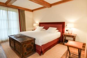 a hotel room with a bed and a table at Hostellerie De Levernois in Levernois +70 photos