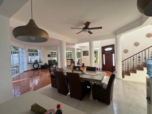 a dining room and living room with a table and chairs at Villa La Dueña in San Felipe de Puerto Plata