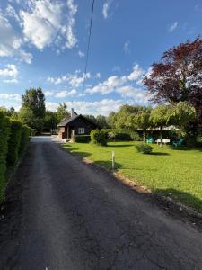 an empty road in front of a house at Le chalet de l Escaut in Bantouzelle
