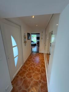 a hallway of a house with a floor at Le chalet de l Escaut in Bantouzelle