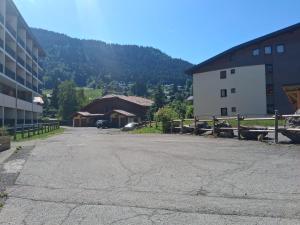 an empty parking lot in front of a building at Whitebearlodge in Arâches-la-Frasse +4 photos